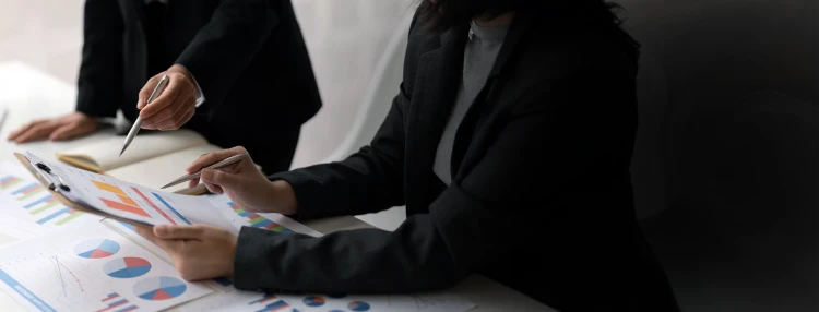 Ross corporate Associates reviewing spreadsheets