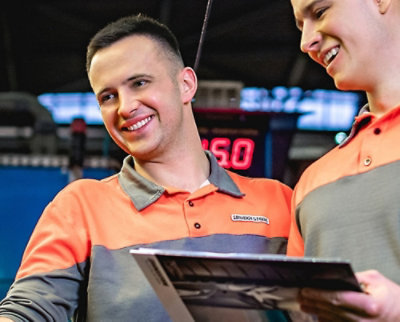 A man and woman looking at a magazine.