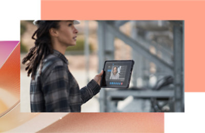 A person in a hard hat holding a tablet