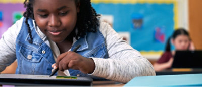 A child drawing on a tablet.
