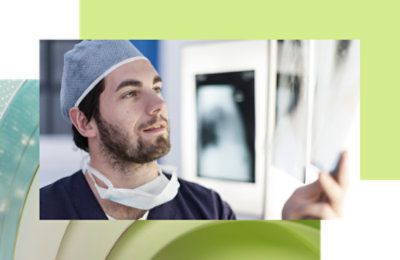 A man wearing a surgical mask and scrubs.