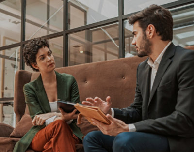 A man and a woman sitting on a couch.