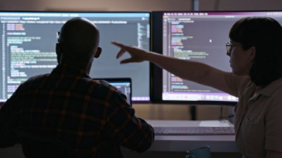 A lady pointing at computer screen.