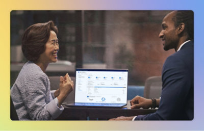 A man and women looking at the laptop screen and discussing