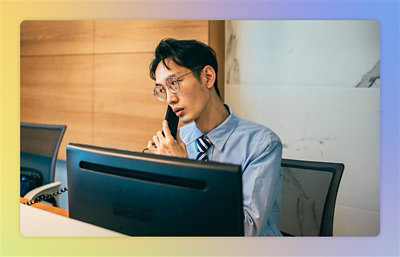 A man wearing glasses and talking over a call