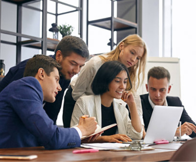 A group of people looking at a laptop