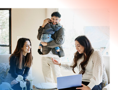 Family enjoying time together at home with a young child on an adult's shoulders 
