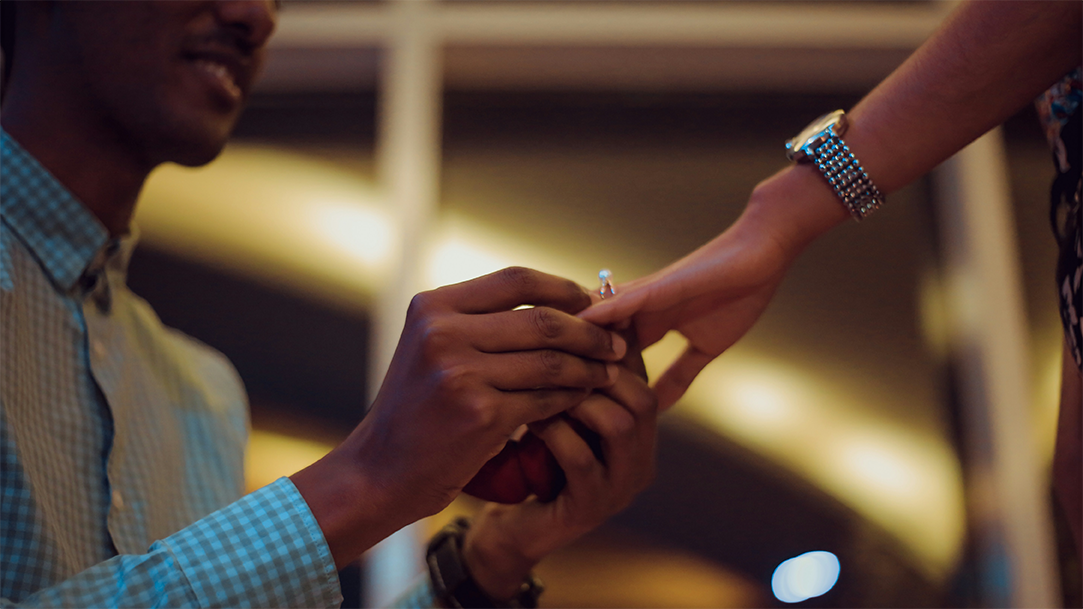 A person places a ring on their partner’s hand