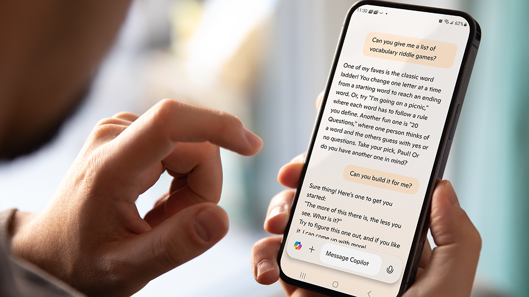 A phone with the Copilot app open on its screen displays a conversation with the AI about vocabulary riddle games