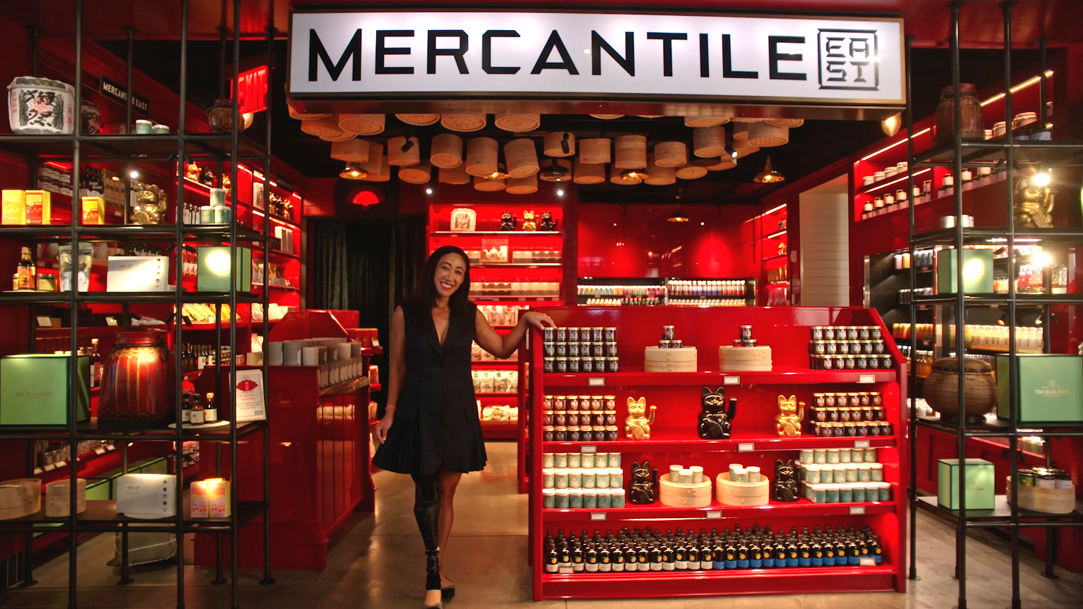 Image of a woman standing in front of her MERCANTILE store