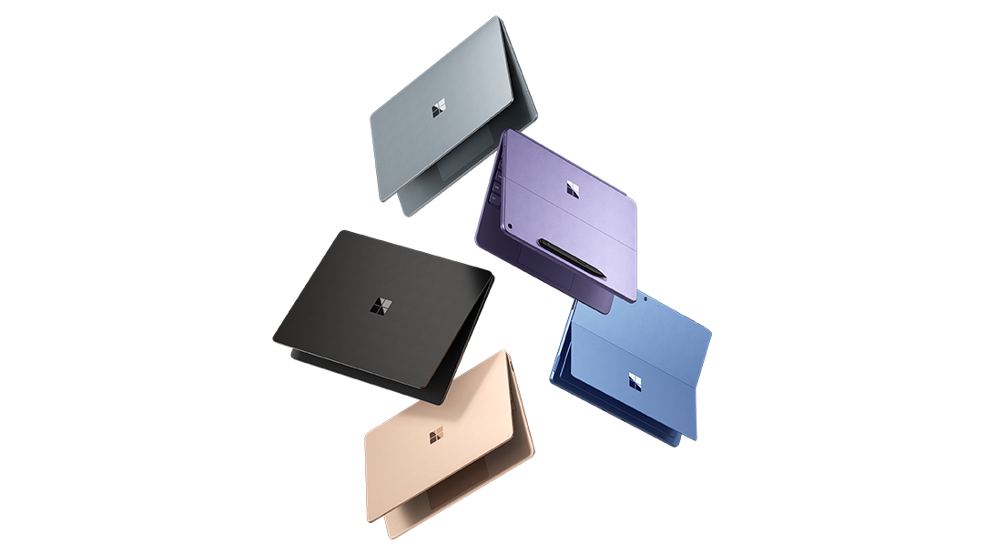 Three Surface Laptop Copilot+ PCs and two Surface Pro Copilot+ PCs juggling in the air