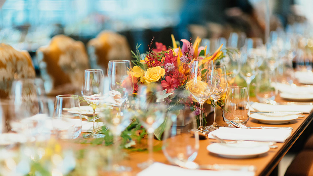 White ceramic dinnerware laid across a table at an event