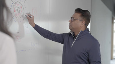 A person writing on a whiteboard about AI and GPT