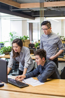 A group of people looking at a computer.
