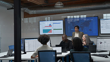 CISO (chief information security officer) collaborating with practitioners in a security operations center.